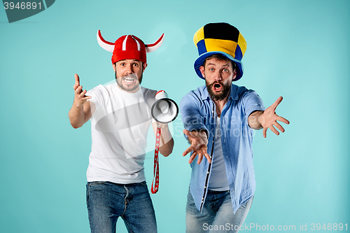 Image of The two football fans with mouthpiece over blue