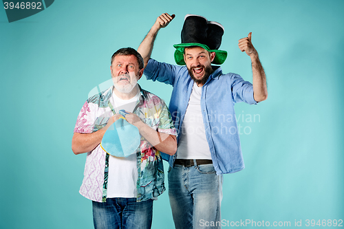 Image of The two football fans over blue