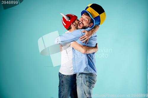 Image of The two football fans over blue