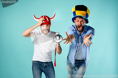 Image of The two football fans with mouthpiece over blue