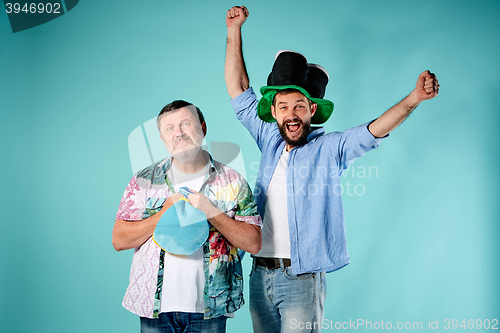 Image of The two football fans over blue