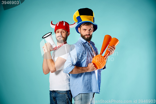 Image of The two football fans with mouthpiece over blue