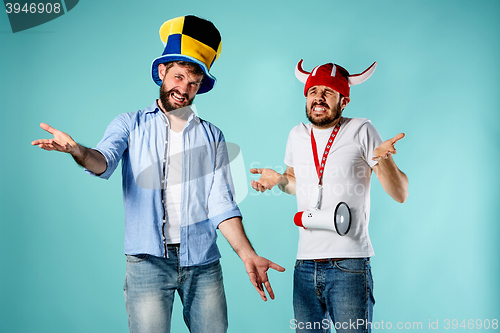 Image of The two football fans with mouthpiece over blue