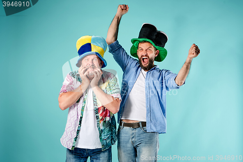 Image of The two football fans over blue