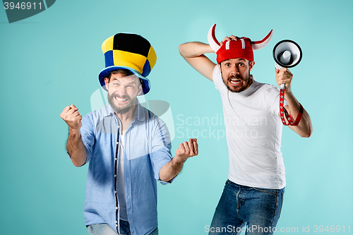 Image of The two football fans with mouthpiece over blue