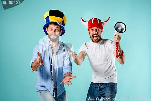 Image of The two football fans with mouthpiece over blue