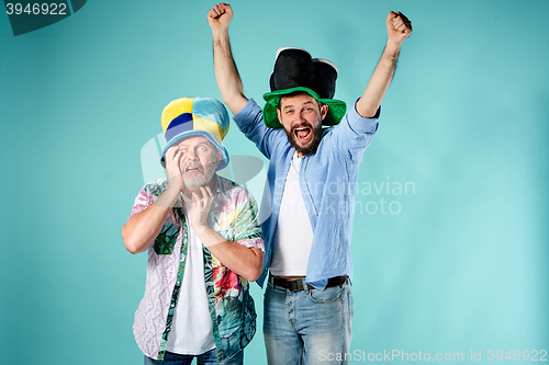 Image of The two football fans over blue