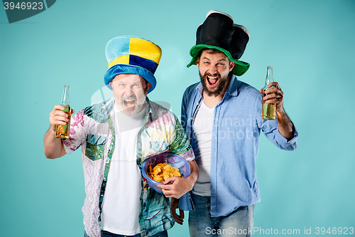 Image of The two football fans over blue