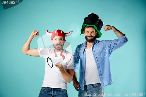 Image of The two football fans with mouthpiece over blue