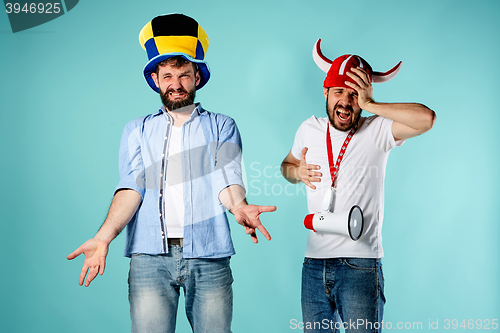 Image of The two football fans with mouthpiece over blue