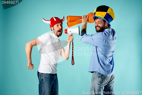 Image of The two football fans with mouthpiece over blue