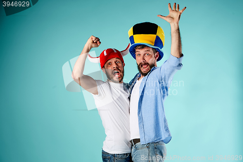 Image of The two football fans over blue