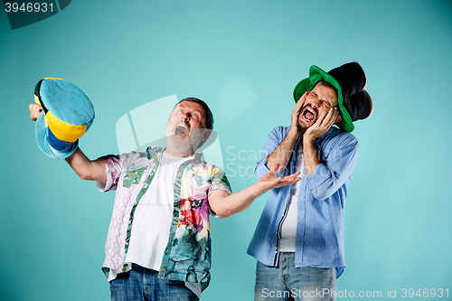 Image of The two football fans over blue