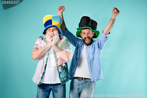 Image of The two football fans over blue