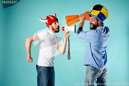 Image of The two football fans with mouthpiece over blue