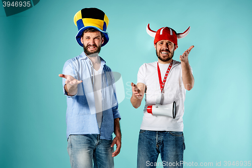 Image of The two football fans with mouthpiece over blue