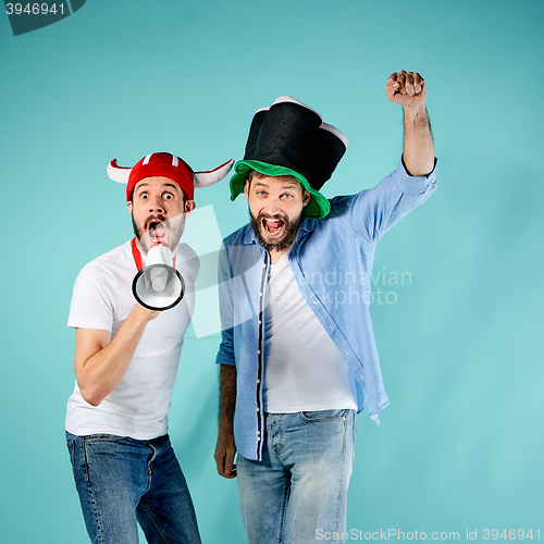 Image of The two football fans with mouthpiece over blue