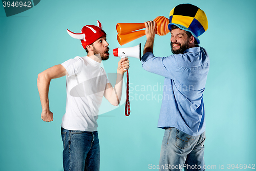 Image of The two football fans with mouthpiece over blue