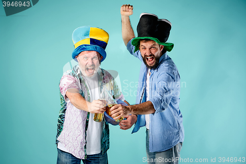 Image of The two football fans over blue