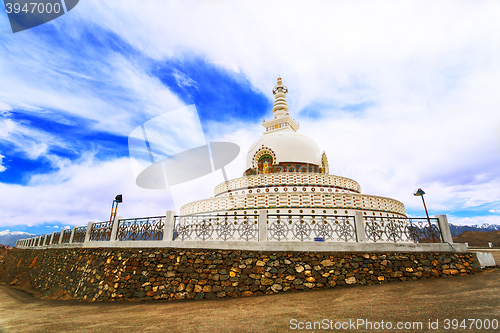 Image of Shanti Stupa on a background cloudy sky