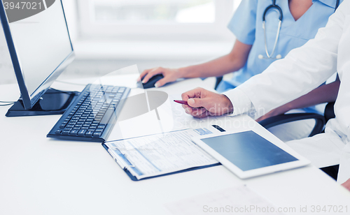 Image of group of doctors looking at tablet pc