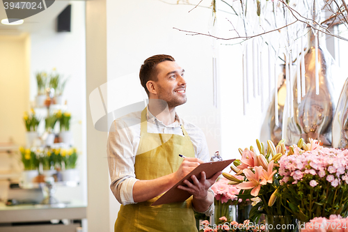 Image of florist man with clipboard at flower shop