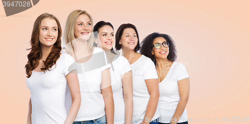 Image of group of happy different women in white t-shirts