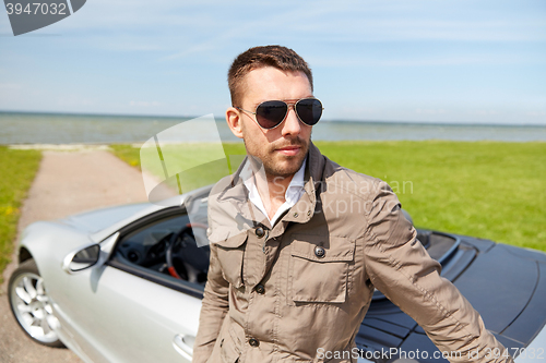 Image of man near cabriolet car outdoors