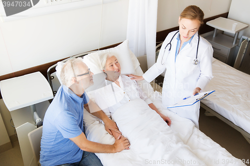 Image of senior woman and doctor with clipboard at hospital