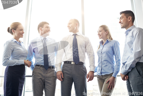 Image of smiling businesspeople meeting in office