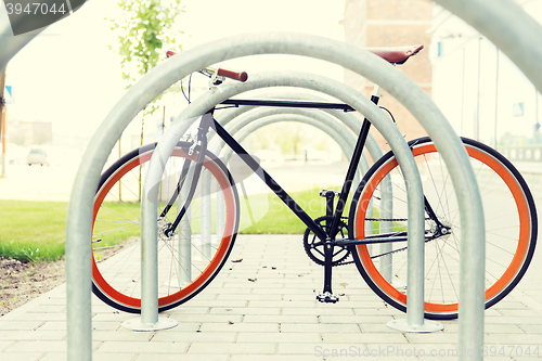 Image of close up of fixed gear bicycle at street parking