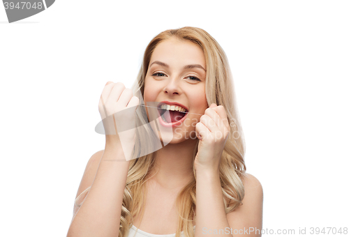 Image of happy young woman with dental floss cleaning teeth