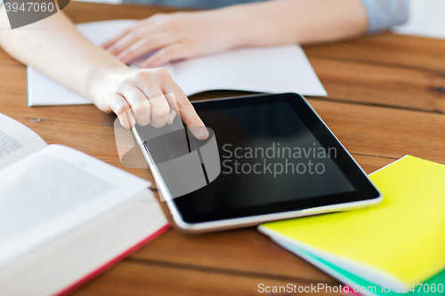 Image of close up of student with tablet pc and notebook