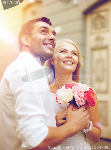 Image of couple with flowers in the city