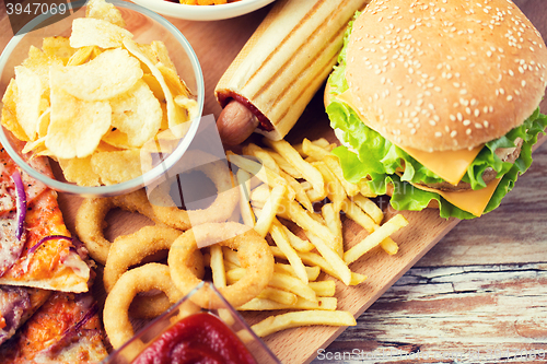 Image of close up of fast food snacks on wooden table