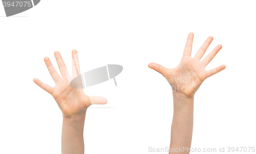 Image of close up of little child hands raised upwards