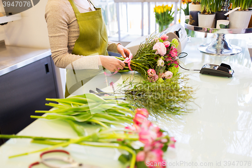 Image of close up of woman making bunch at flower shop