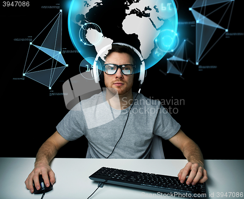 Image of man in headset with computer over earth projection