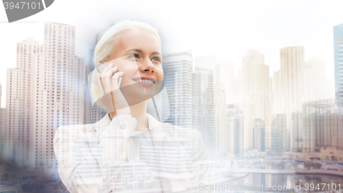 Image of smiling businesswoman with smartphone outdoors