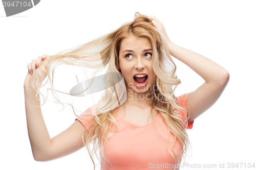 Image of woman holding strand of her hair