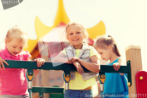 Image of happy little girls on children playground