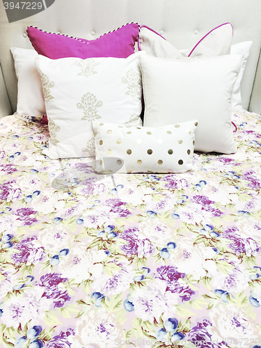 Image of White and purple bed linen with floral design
