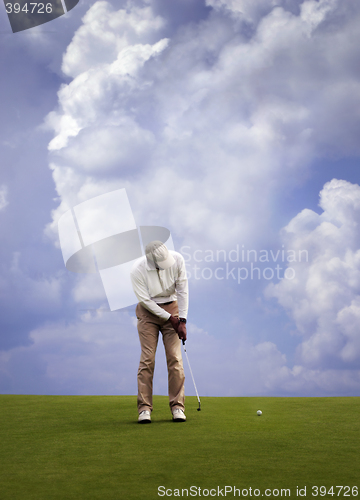 Image of Man playing golf.