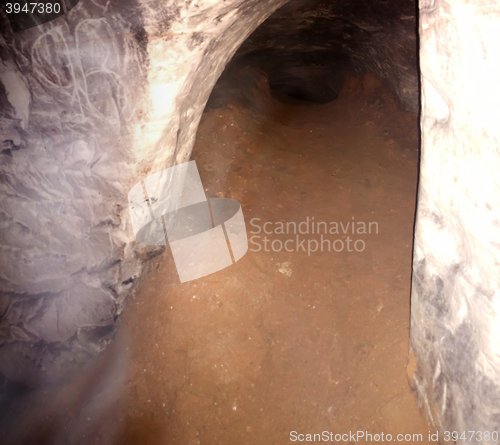 Image of digger, miner tunnel deeply underground.