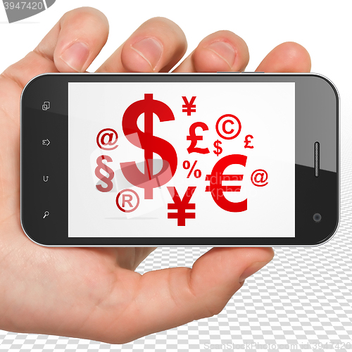 Image of Business concept: Hand Holding Smartphone with Finance Symbol on display