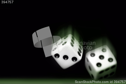 Image of Rolling Two dices on black background