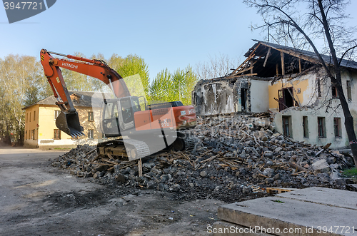 Image of Digger demolishing houses for reconstruction