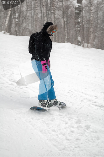 Image of Woman doing exercise on snowboard