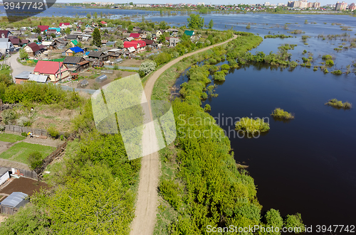 Image of Dam separates residential area from spread river