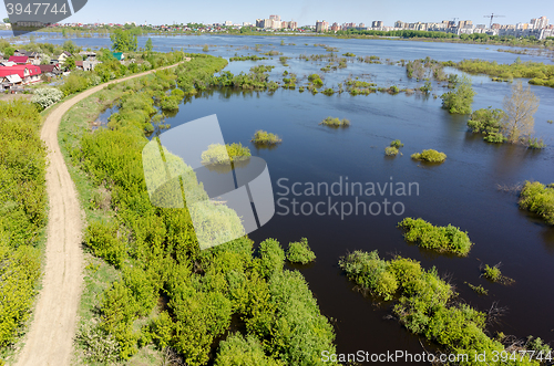 Image of Dam separates residential area from spread river